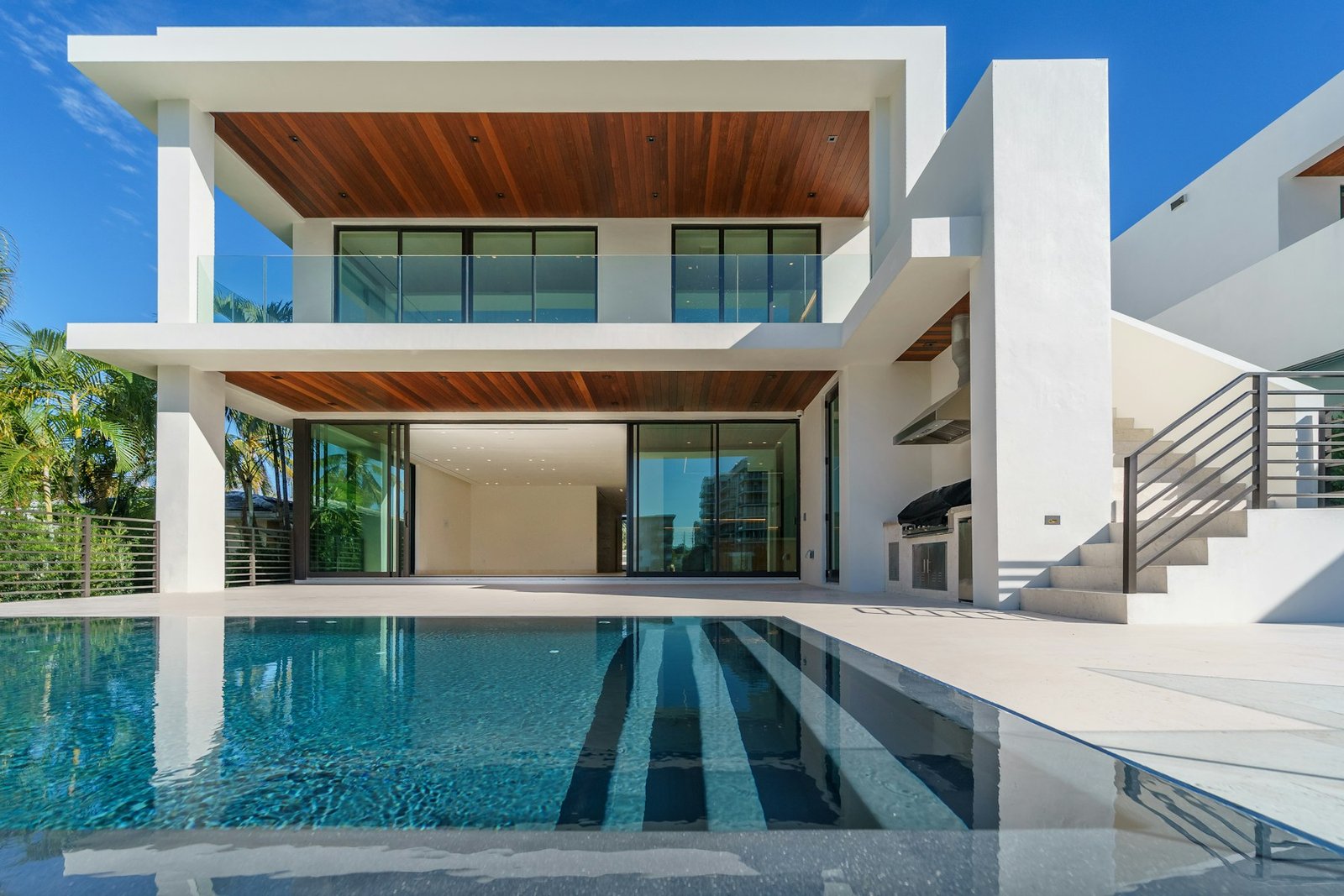 Contemporary two-storey villa with floor-to-ceiling glazing at dusk